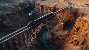 Train on towering bridge, majestic natural landscape from above. Aerial view train passing through photo