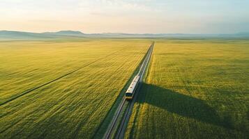 Golden plains and train journey, freedom captured from above. Aerial view train passing through photo