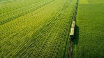 Endless fields with train, aerial view of serene natural expanse. Aerial view train passing through photo