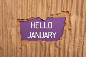 Hello january message written on ripped torn cardboard paper with purple background. Conceptual hello january symbol. Copy space. photo