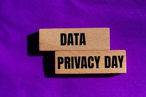 Data privacy day message written on wooden blocks with purple background. Conceptual data privacy day symbol. Copy space. photo