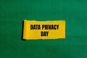 Data privacy day message written on ripped torn yellow paper piece with green background. Conceptual data privacy day symbol. Copy space. photo