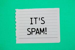 It's spam message written on ripped torn paper piece with green background. Conceptual it's spam symbol. Copy space. photo