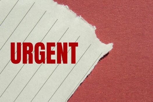 Urgent message written on ripped torn lined paper with red background. Conceptual urgent word symbol. Copy space. photo