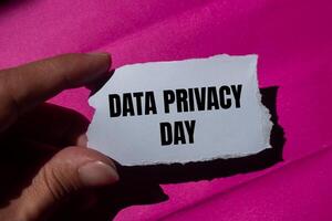 Data privacy day message written on ripped torn paper piece with a pink background. Conceptual data privacy day symbol. Copy space. photo