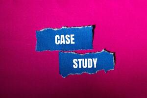 Case study message written on ripped torn blue paper pieces with pink background. Conceptual case study symbol. Copy space. photo