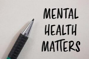 Mental health matters message written on white paper with a pen. Conceptual mental health matters symbol. Copy space. photo