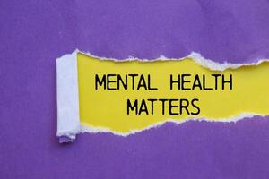 Mental health matters message written on ripped torn purple paper with yellow background. Conceptual mental health matters symbol. Copy space. photo