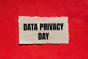 Data privacy day message written on ripped torn paper piece with red background. Conceptual data privacy day symbol. Copy space. photo