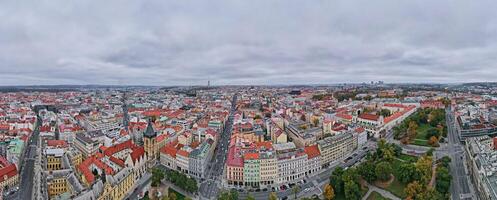 Prague architecture, aerial view. Historical buildings with red roofs in European city. Birds eye view of cityscape of Praha, Czech Republic photo