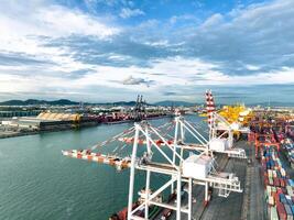 Logistics and transportation of container cargo ship at ship port. Container truck and crane bridge in shipyard. Import export and transport industry. Terminal port for export transport by ship. photo