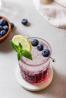 Cocktail with ice in a glass on marble photo