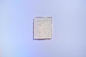 Gel rectangle smear on purple holographic background photo