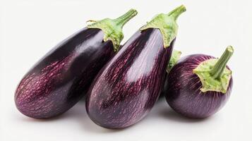 Colorful pumpkin aubergines show off their smooth skin and shapes on a white background photo
