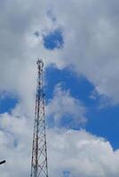 Backgrounds of signal transmitter tower with cloudy blue sky background in Cicalengka Area, Indonesia. Radio and communications technology facilities. Internet and signal. photo