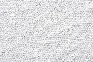 Close up texture of soft white terry cloth towel fabric with subtle patterns and details. photo