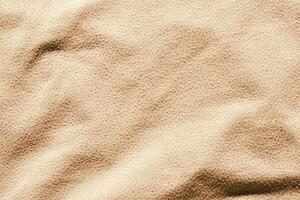 Close up texture of beige fabric with soft wavy patterns and shadow highlights. photo
