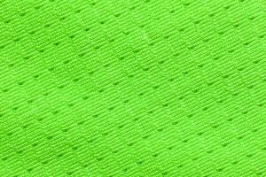 Bright neon green textured fabric with intricate zigzag pattern for fashion and design. photo