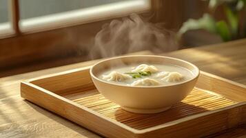 Steaming Wonton Soup in Bowl on Bamboo Tray Asian Cuisine photo
