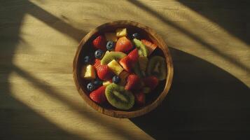 Sunlit Wooden Bowl of Fresh Fruit Salad Strawberries Kiwi Pineapple Blueberries photo