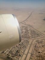 High angle view of desert land and city from airplane photo