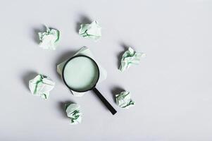 Burnout breaks concept. Magnifier among the papers for writing on the desk top view photo