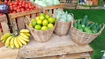 Close Up Banana, Lime and Guava without seeds in basket displayed on wooden board in market photo