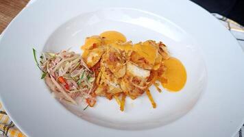 Tasty Yellow seasoned chicken with stir-fried vegetables served on a white plate photo