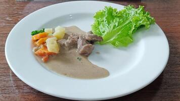 Beef Steak Traditional rujak seasoned with a vegetarian mix of carrot potatoes served on a white plate photo