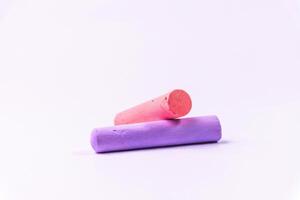 Crayons of different colors arranged on a white background. Education photo