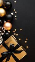 Black and Gold Christmas Arrangement with Gift Box and Baubles on Black Background. Elegant, Festive Christmas Banner, Template, Copy Space, Social Media Post photo