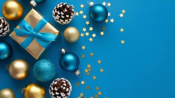 Light Blue and Gold Christmas Arrangement with Gift Box and Baubles on Light Blue Background. Elegant, Festive Christmas Banner, Template, Copy Space, Social Media Post photo