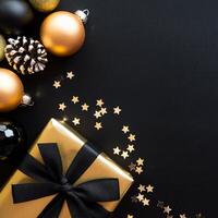 Black and Gold Christmas Arrangement with Gift Box and Baubles on Black Background. Elegant, Festive Christmas Banner, Template, Copy Space, Social Media Post photo