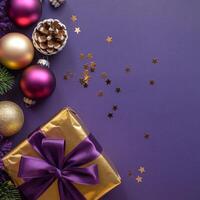 Purple and Gold Christmas Arrangement with Gift Box and Baubles on Purple Background. Elegant, Festive Christmas Banner, Template, Copy Space, Social Media Post photo