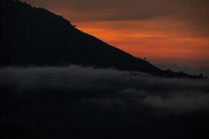 a mountain with a bird on the top of it photo