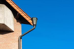 A close-up of the corner roof and roof gutter on an building. photo