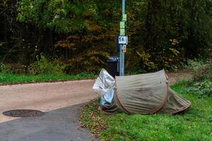 Tent set up on pathway in a public park during autumn season photo