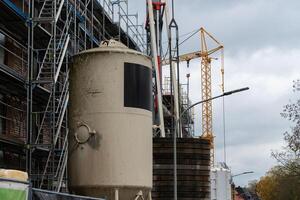 Construction site showing cement mixer and scaffolding in progress photo
