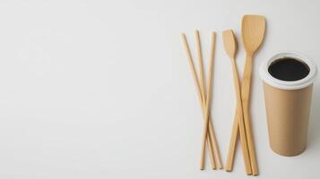 Bamboo utensils and a cup of coffee on a white surface photo