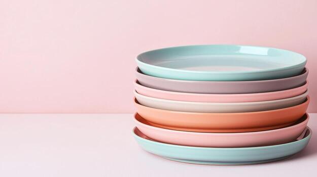 Elegant Stack of Colorful Dinner Plates Against a Soft Pink Background for Modern Dining Concepts photo