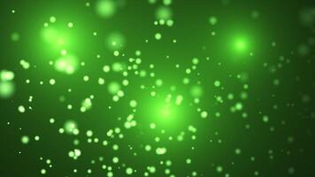 Abstract animation concept of sparkling particles for celebrating birthdays and holidays. 4k loop bokeh background with light particles on green background. Animation footage with light video