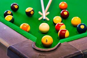 Vivid Pool Table Scene with Numbered Balls and Cue Stick photo