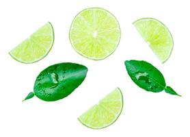 Top view set of fresh green lemon fruit in half and slices or quarters with green leaves isolated on white background with clipping path photo