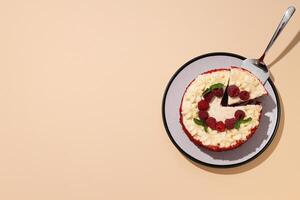 Red velvet cake with berries on plate on beige background, space for text photo