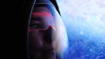 Astronaut gazes at planet Earth through his high-tech helmet visor, red lights reflecting on his face. Advanced gear enhances astronaut's view, creating mesmerizing connection to space. video
