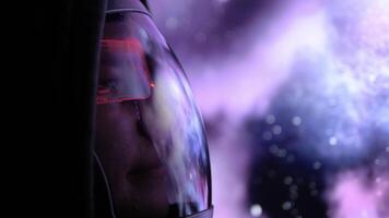 Astronaut looks at stunning purple nebula through window of spaceship surrounded by bright stars light reflects off cosmic scene as astronaut drifts through space, immersing himself universe. video