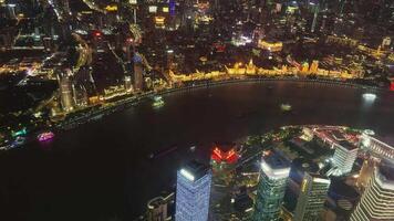 Shanghai's vibrant cityscape at night with the illuminated Bund and towering skyscrapers, including the distinctive Shanghai Tower. video