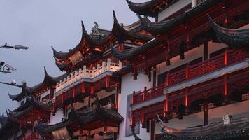 Yu Gardens in Shanghai features intricate Chinese buildings with ornate carvings, warm lighting, and a mix of modern and traditional elements. video
