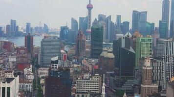 View of Shanghai's skyline with the Oriental Pearl Tower, modern skyscrapers, and the Huangpu River, showcasing the city's dynamic urban landscape. video