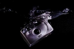 Drowning analog camera symbolizing technological evolution photo